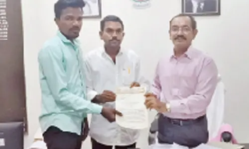TNSF Kurnool parliament general secretary Boggula Praveen and others submitting a representation to DRO in Kurnool on Monday.