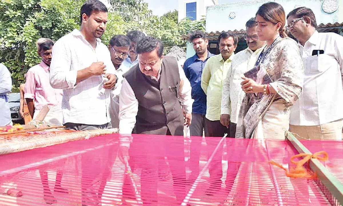 District Collector K Venkataramana Reddy and Invest India Committee head Jigisha Tiwari Mishra observing sari weaving process in Venkatagiri on Tuesday
