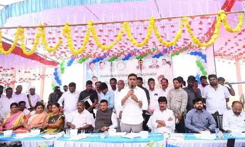 Rajampet MP P Mithun Reddy speaking at a programme at Kurabalakota on Tuesday. District Collector PS Girisha is also seen.