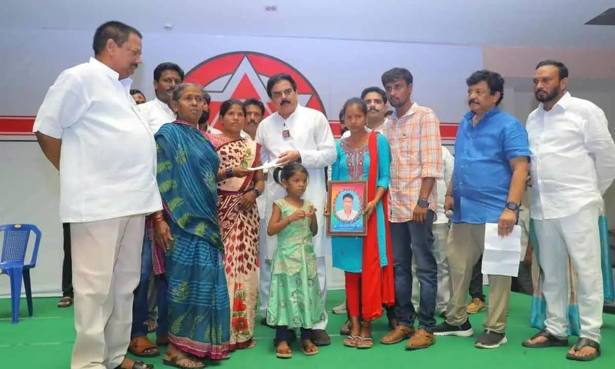 Jana Sena Party political affairs committee chairman Nadendla Manohar hands over financial assistance to the family of a deceased Jana Sena activist in Kakinada on Thursday
