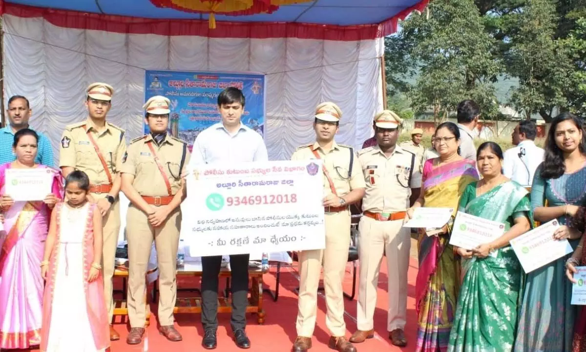 Collector Sumit Kumar unveils the Redressel cell toll-free number in Paderu of Alluri Sitarama Raju district on Saturday. District SP Tuhin Sinha and others also seen.