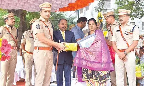 SP Siddharth Kaushal felicitating family members of police personnel in Kadapa on Saturday