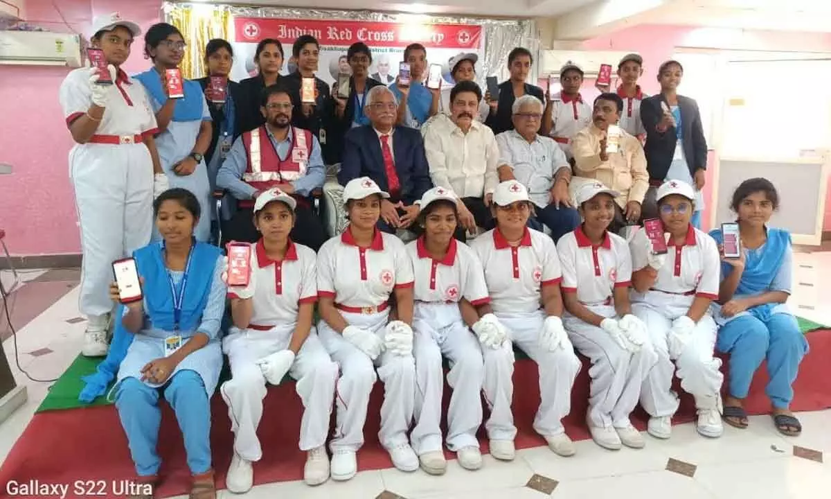 Young volunteers displaying the app developed by AP Red Cross