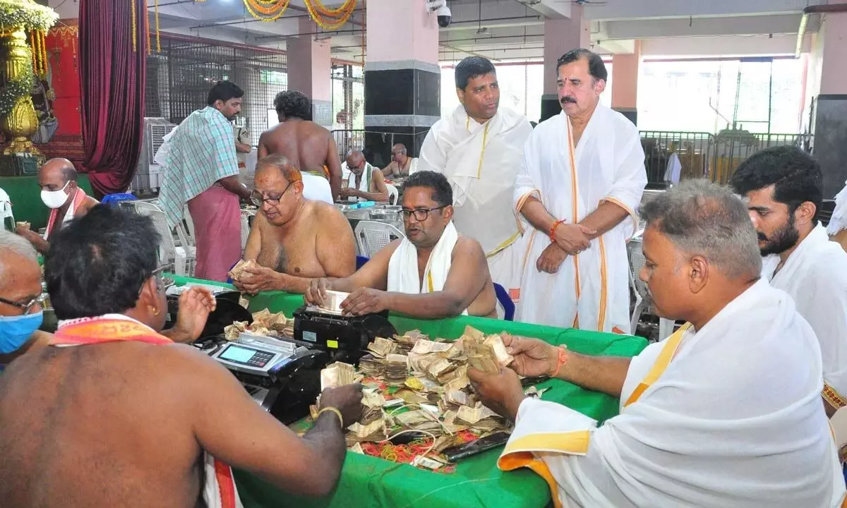 Sri Durga Malleswara Swamy Temple EO KS Ramarao supervising Hundi counting atop Indrakeeladri on Monday