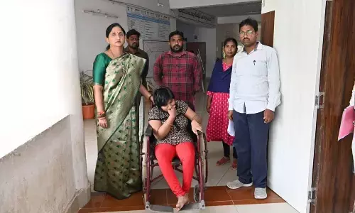 East Godavari district Collector Dr K Madhavi Latha presenting a tricycle to Varshita, a differently abled girl, at the Collectorate in Rajamahendravaram on Monday