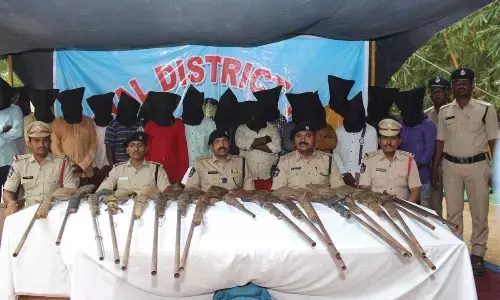 Nandyal SP K Raghuveera Reddy producing the arrested persons and seized weapons before the media at his office in Nandyal on Tuesday