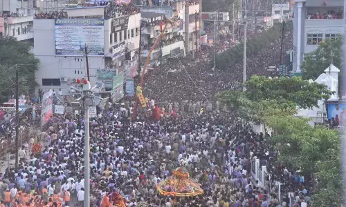 Chief priest B Venkata Rao blesses devotees from atop the Sirimanu (log) during the Sirimanotsavam of Goddess Pydithalli in Vizianagaram on Tuesday