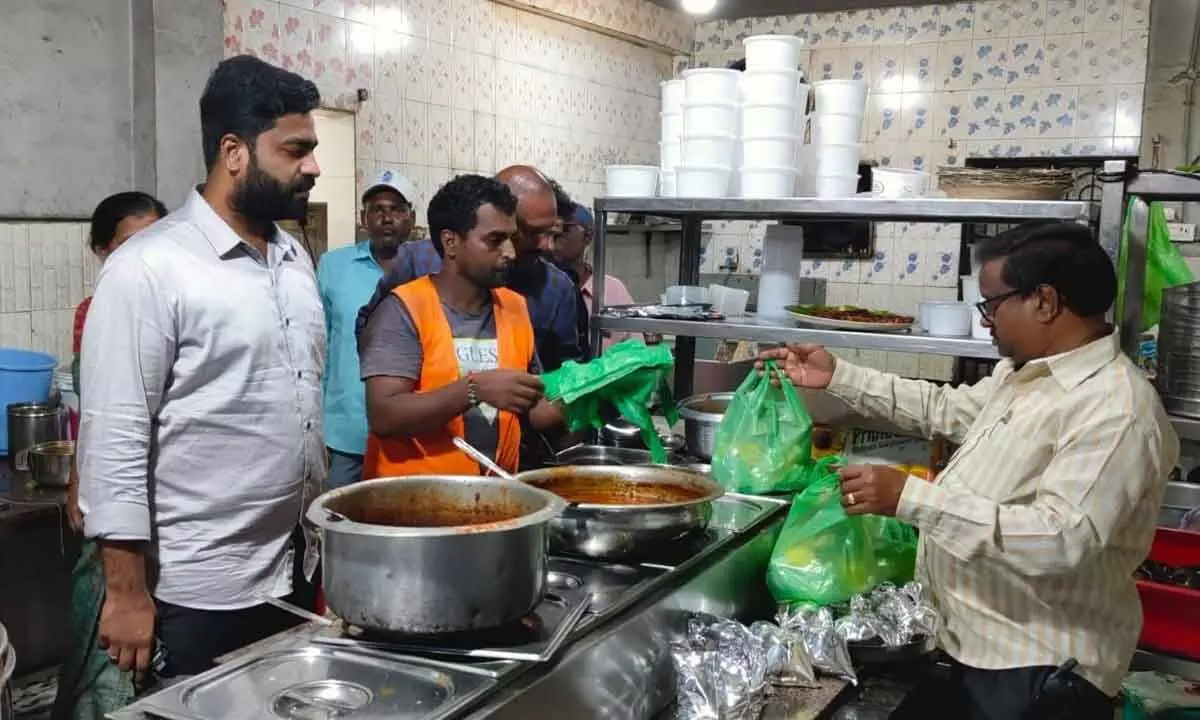 Municipal corporation health officer Dr Yuva Anvesh along with the staff checking the plastic carry bags in a shop in Tirupati city on Thursday