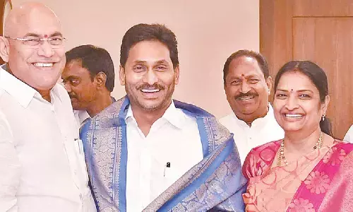 Ministers Ch Srinivasa Venugopala Krishna and Usha Sricharan felicitating Chief Minister  Y S Jagan  Mohan Reddy at his camp  office in  Tadepalli