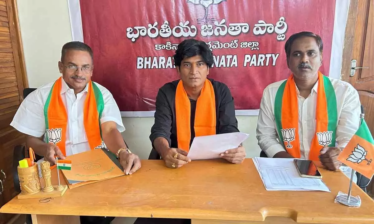 BJP state spokesperson Yarlagadda Ram Kumar addressing the media in Kakinada on Sunday. District BJP president Ch Ram Kumar and District Media Panelist Duvvuri Subrahmanyam are also seen.