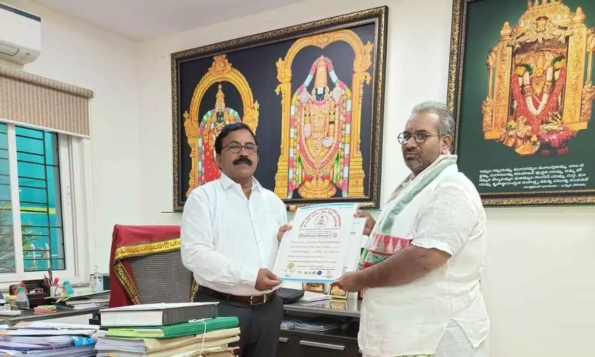 Priest M Phani Kumar receiving PhD from Commissioner of Endowments N Satyanarayana in Vijayawada on Sunday