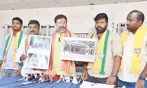 BJP spokesperson G Bhanu Prakash Reddy displaying the photos of old and new Parveta Mandapams before the media in Tirupati on Monday