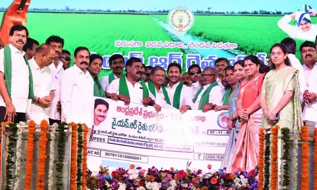 Chief Minister Y S Jagan Mohan Reddy releasing a cheque for Rs 2,204.76 crore under the YSR Rythu Bharosa-PM Kisan scheme at a public meeting at Puttaparthi on Tuesday