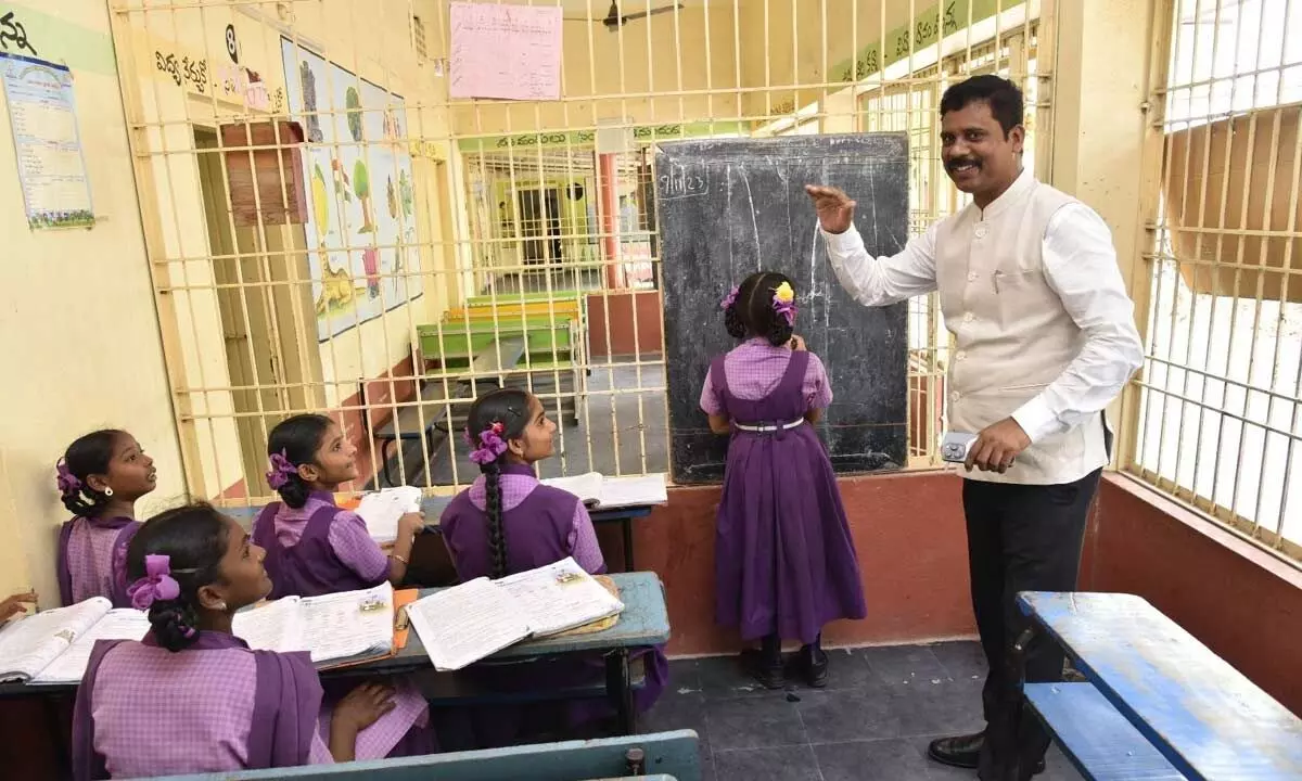NTR district collector S Dilli Rao interacting with students at Kundavari Kandrika school in Vijayawada on Tuesday