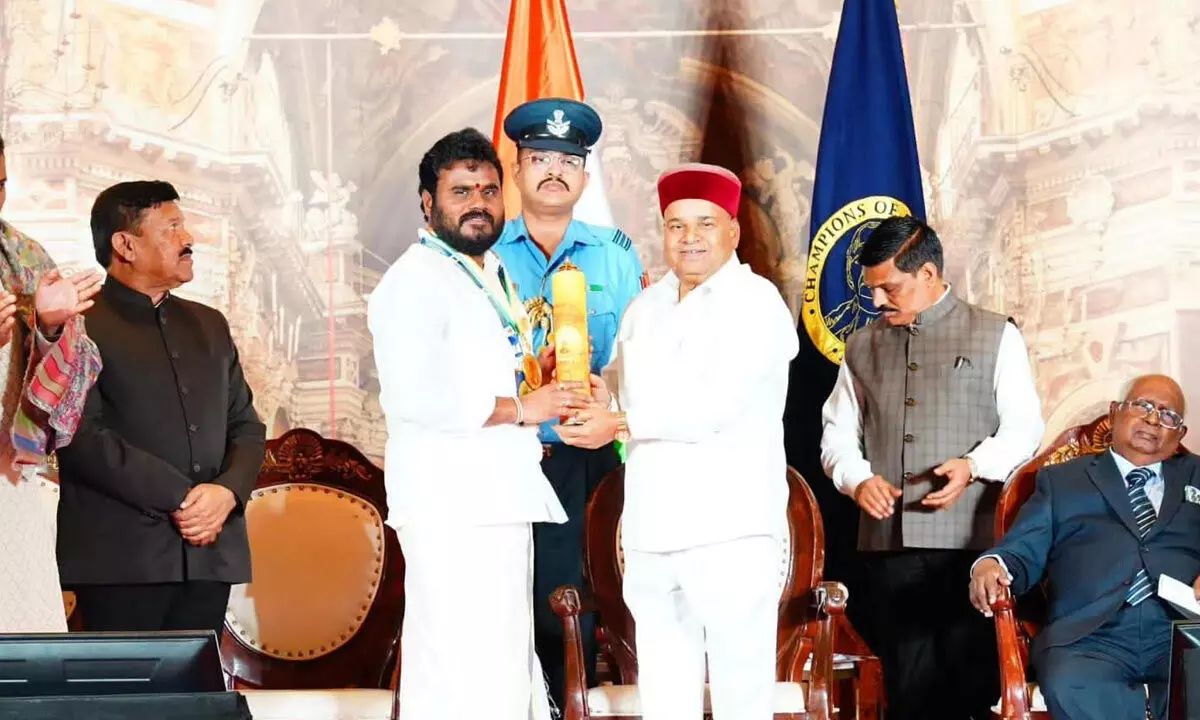 Bode Ramachandra Yadav receiving Champion of Change award from Karnataka Governor Tawarchand Gehlot at Raj Bhavan in Bengaluru on Tuesday