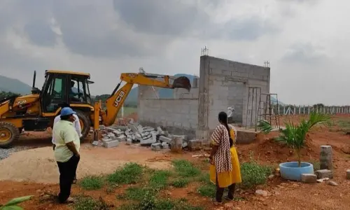 APCRDA authorities removing unauthorised layouts in Nunna village of Vijayawada Rural on Tuesday