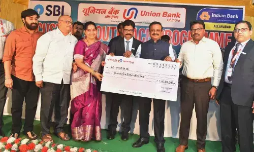 Machilipatnam MP V Balashowry and Krishna district collector P Rajababu handing over cheques to the beneficiaries in Machilipatnam on Thursday