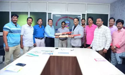 AKNU Sports Board Member and AP Table Tennis Association President V Bhaskara Ram presenting bats to the Physical Education department in Rajamahendravaram on Thursday