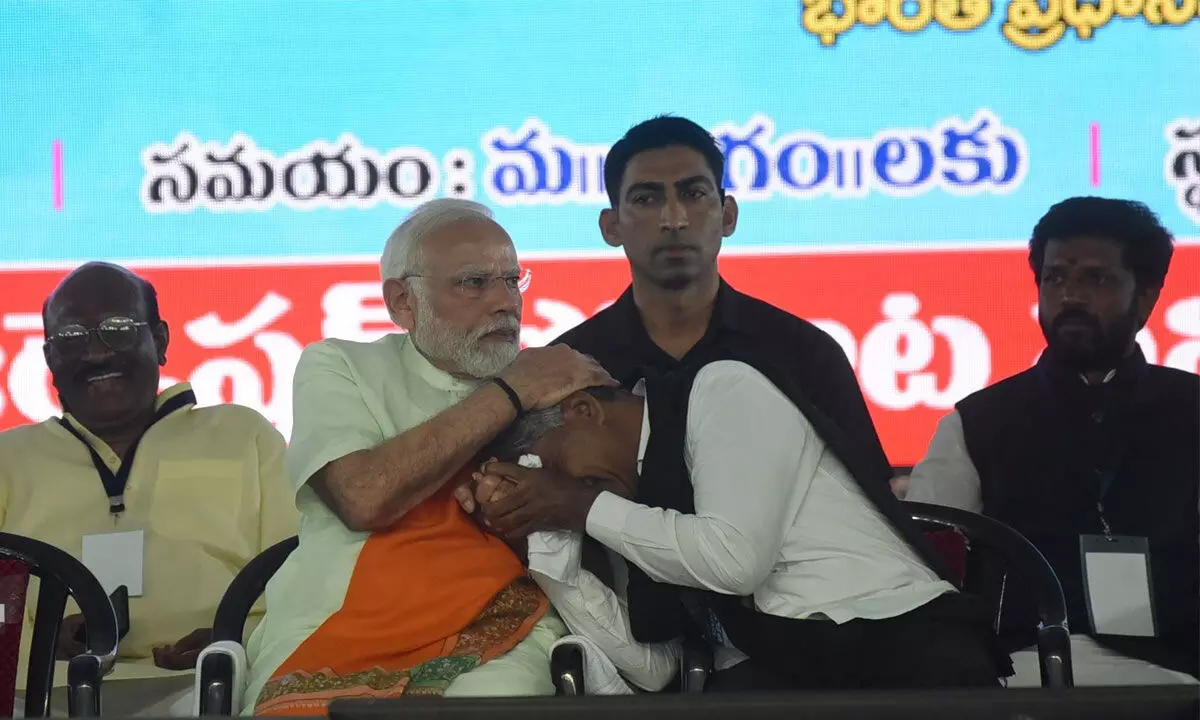 Prime Minister Narendra Modi consoles Madiga Reservation Porata Samithi chief Manda Krishna Madiga who got emotional during a public meeting in Secunderabad on Saturday. Photo: Adula Krishna