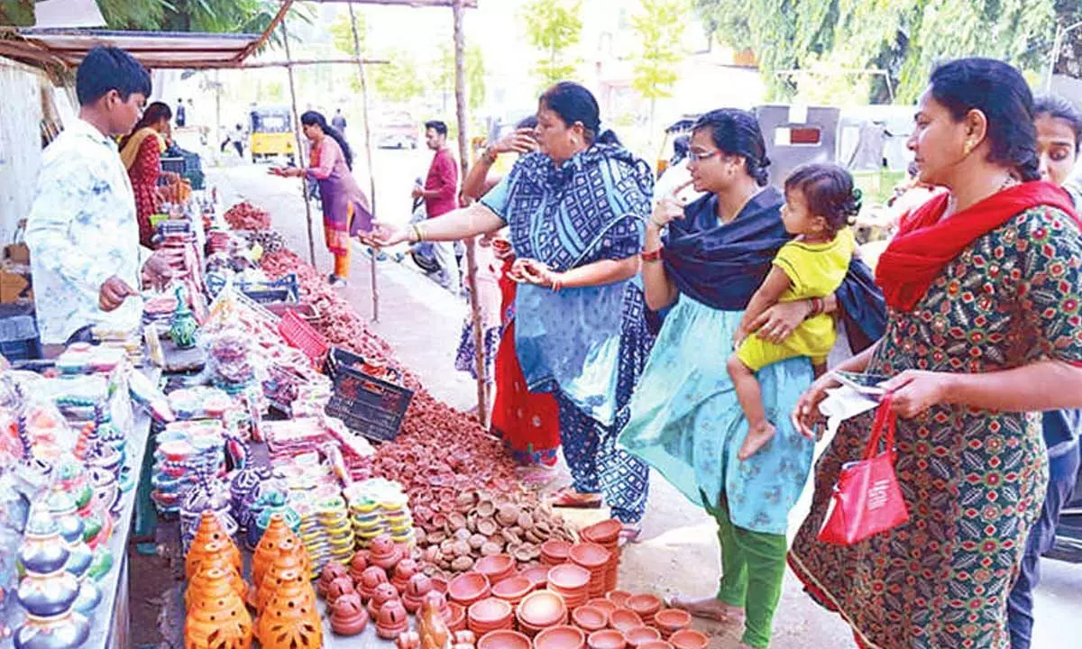 Women are busy buying clay diyas on a footpath in Tirupati on Saturday			 Photos: Kalakata Radhakrishna