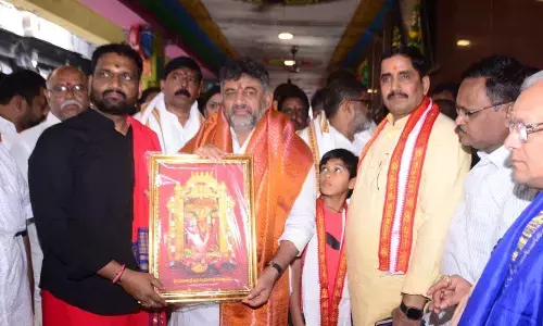 Kanaka Durga temple trust board chairman Karnati Rambabu presenting a portrait of Goddess Kanaka Durga to Karnataka Dy CM D K Shiva Kumar at the temple in Vijayawada on Saturday