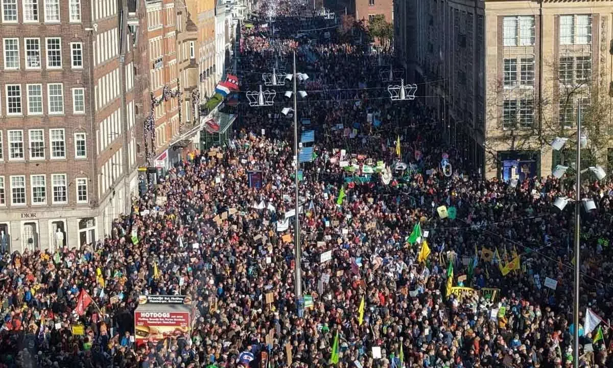 Tens of thousands march for climate action in Dutch capital