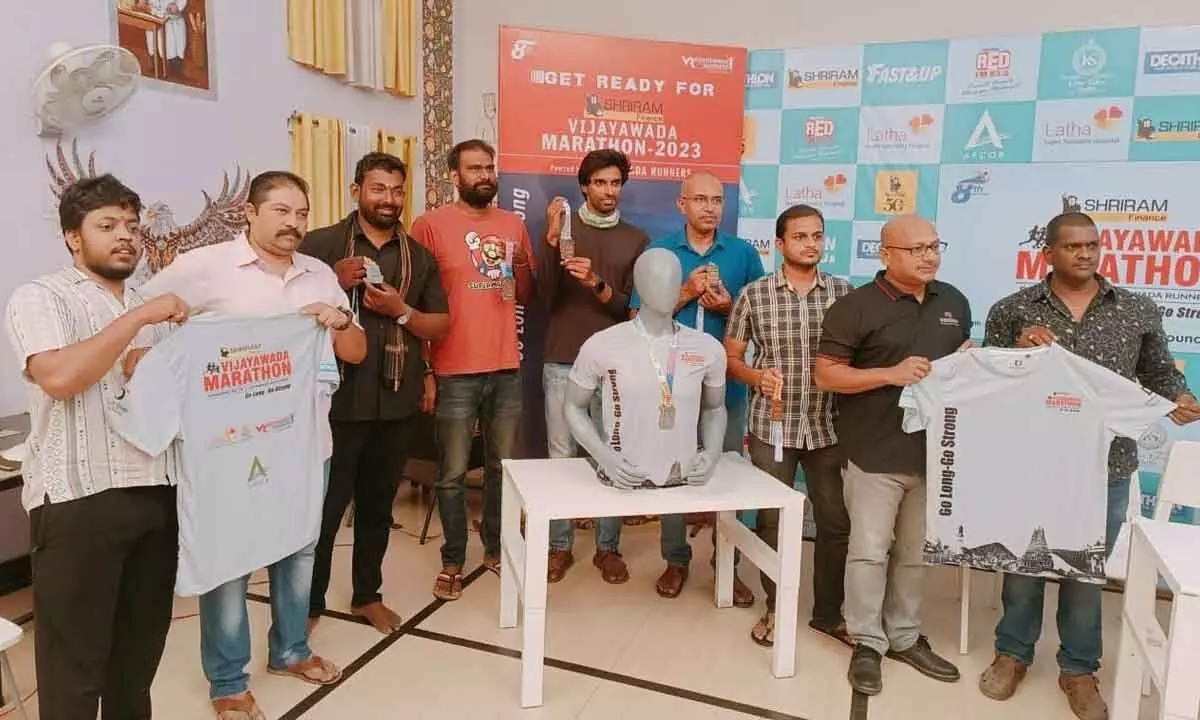 Marathon organisers releasing T-shirts of Vijayawada Marathon on Thursday