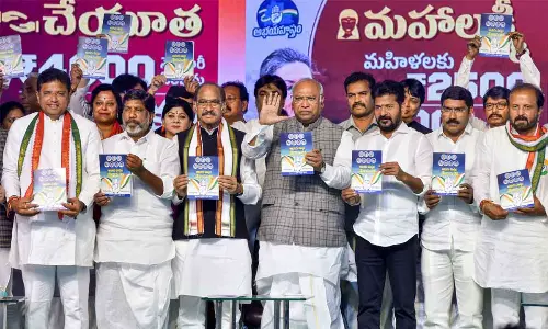 Congress president Mallikarjun Kharge with TPCC president A Revanth Reddy and AICC Telangana in-charge Manikrao Thakare releases partys manifesto in Hyderabad on Friday. Photo G Ramesh