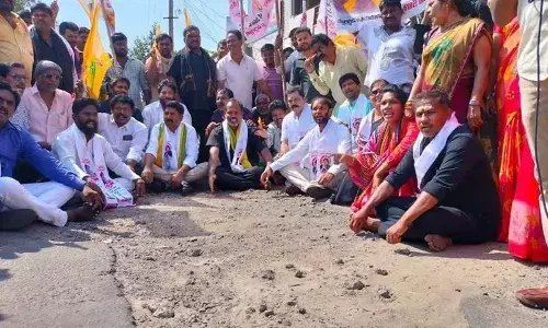 TDP and JSP leaders staging a dharna against bad roads in Visakhapatnam on Saturday