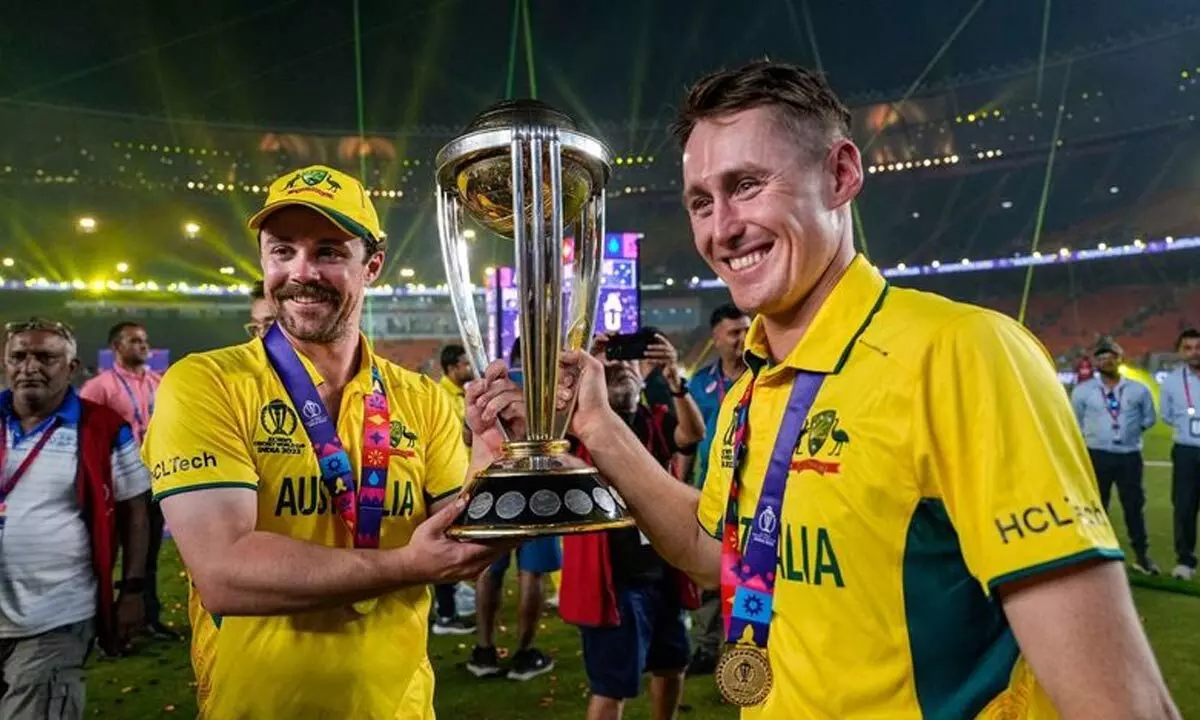 Australias batters Travis Head and Marnus Labuschagne celebrate with trophy after winning the ICC Men’s Cricket World Cup 2023, at the Narendra Modi Stadium, in Ahmedabad on Sunday