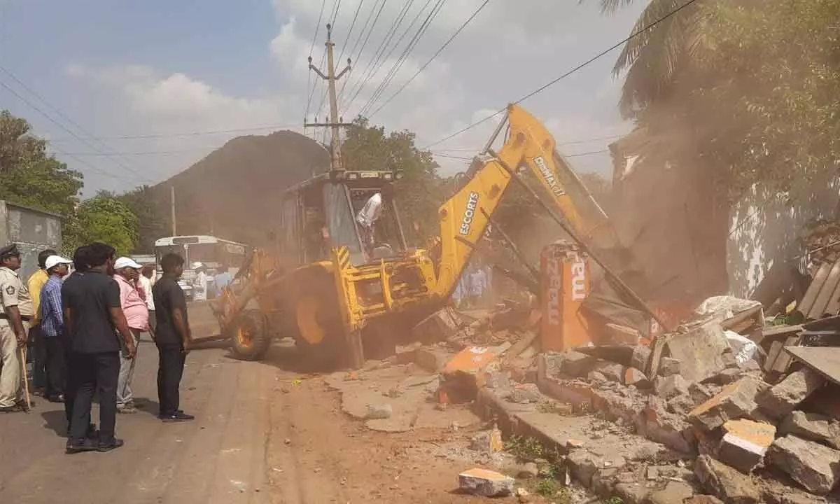 GVMC officials carrying out road expansion work for the BRTS project in Visakhapatnam