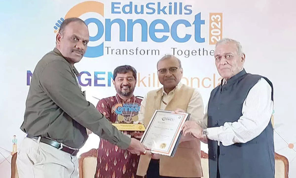 PB Siddhartha College of Arts & Science Training and Placements Officer Kavuri Sridhar receiving award in Goa on Sunday