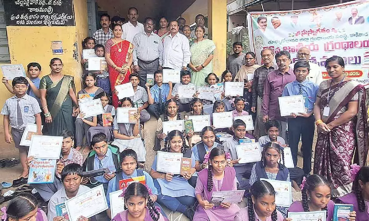 Students, who won prizes in various competitions organised during National Library Week in Rajamahendravaram on Monday