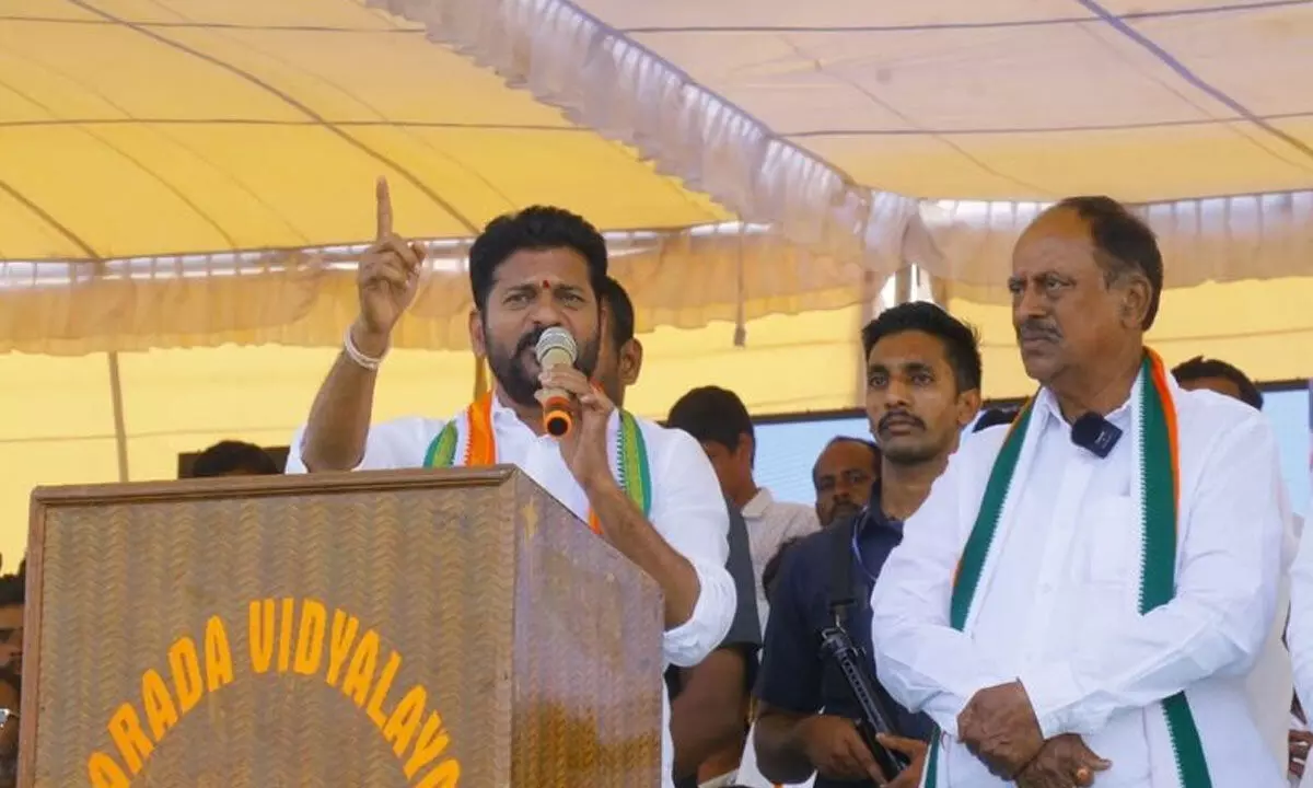 TPCC president A Revanth Reddy addressing a public meeting at Parkal on Monday. Congress Parkal candidate Revuri Prakash Reddy is also seen