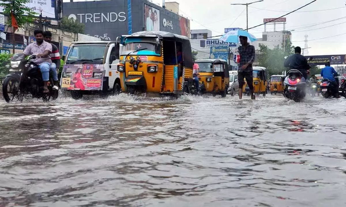 Vehicles wading through rainwater on the busy Trunk Road in Nellore city on Tuesday