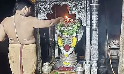 Priest performing puja to Lord Trikoteswara Swamy on Kotappakoda hillock on Monday on the occasion of Karthika Somavaram