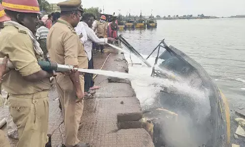 Firefighters dousing the flames at the Fishing Harbour in Visakhapatnam on Monday . Photo:  Balivada Gopi Krishna