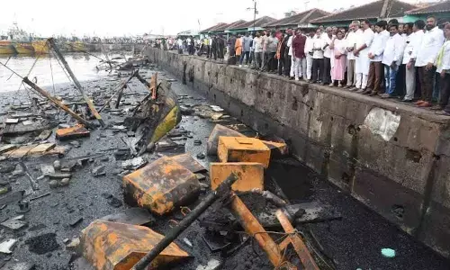 District officials and public representatives at the incident spot in Fishing Harbour in Visakhapatnam on Tuesday