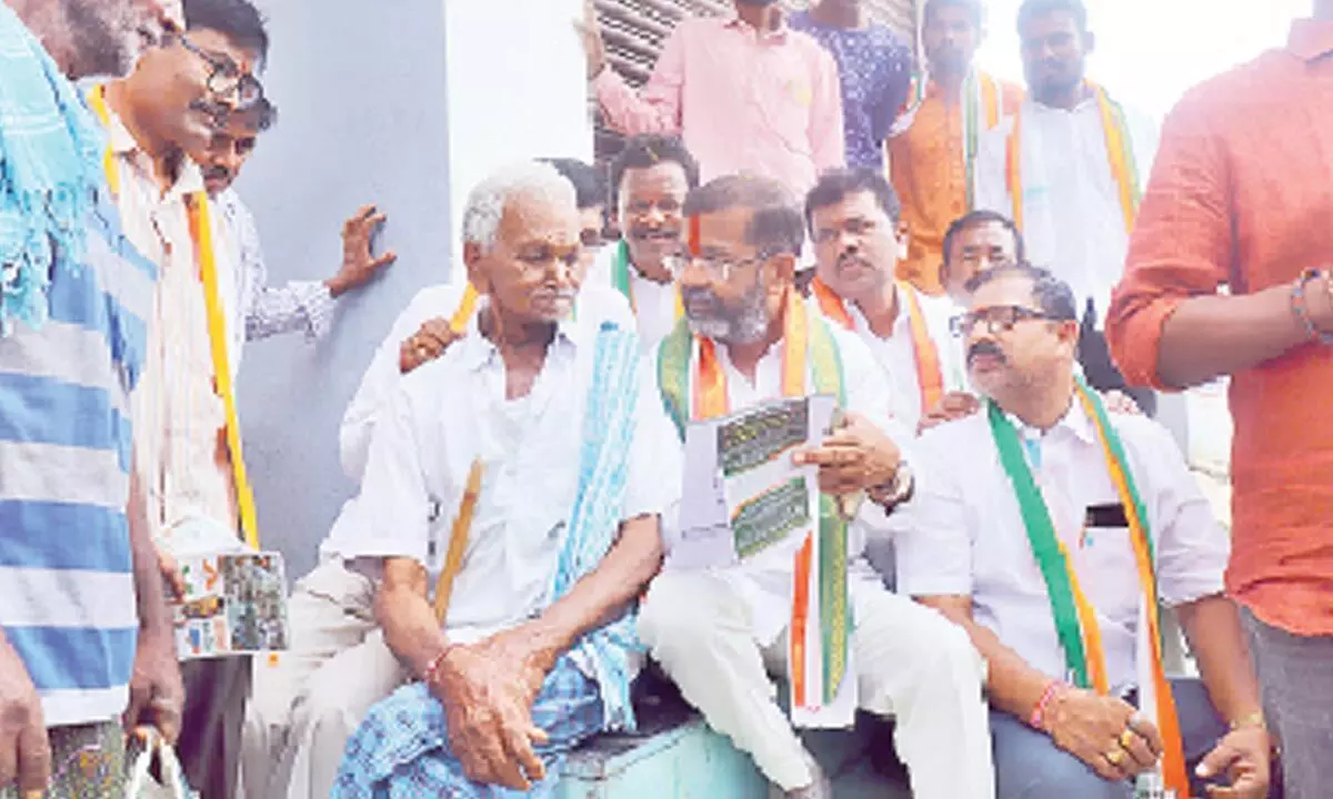 Congress Warangal West candidate Naini Rajender Reddy interacting with an elderly man during his election campaign in Hanumakonda on Tuesday