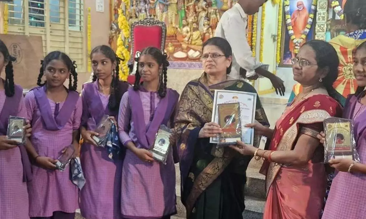District Education Officer Renuka with students at Satya Sai Seva Sanshta in Vijayawada on Tuesday