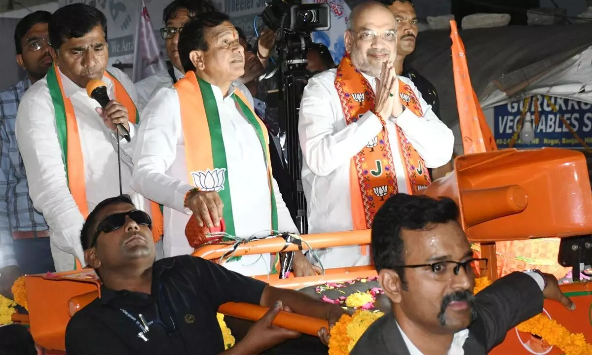 Home Minister Amit Shah greets people a roadshow at Khairatabad in Hyderabad on Saturday. Photo: G Ramesh