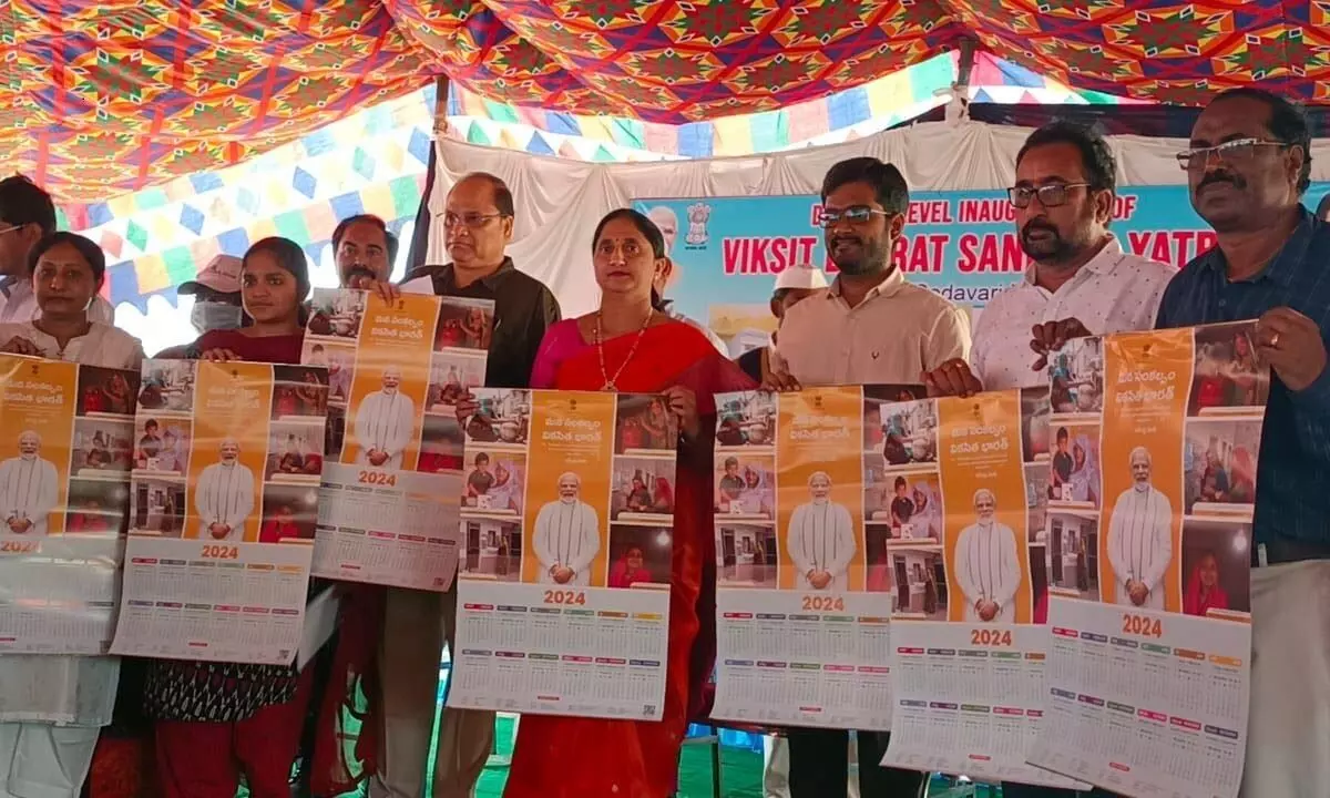 East Godavari District Collector K Madhavi Latha and other officials displaying brochures of the Central government schemes at the Viksit Bharat Sankalp Yatra held at Kolamuru village on Saturday