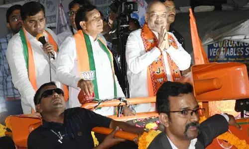Home Minister Amit Shah greets people a roadshow at Khairatabad in Hyderabad on Saturday. Photo: G Ramesh