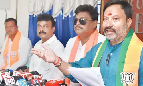 BJP state spokesperson G Bhanuprakash Reddy speaking to media in Tirupati on Saturday. State secretary S Muni Subramanyam and others are also seen.