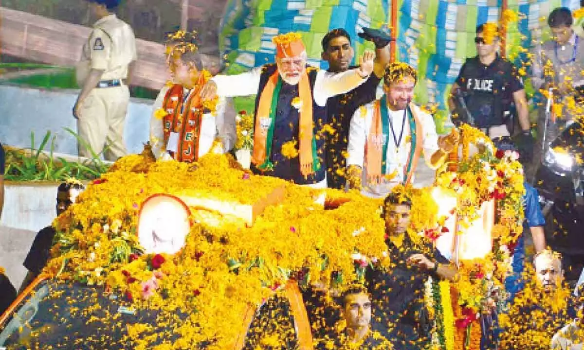 Prime Minister Narendra Modi with Telangana BJP chief and Union Minister G Kishan Reddy and MP K Laxman during a roadshow from RTC Crossroads to Kachiguda ahead of the Telangana  Assembly election, in Hyderabad on Monday 			Photo: Srinivas Setty