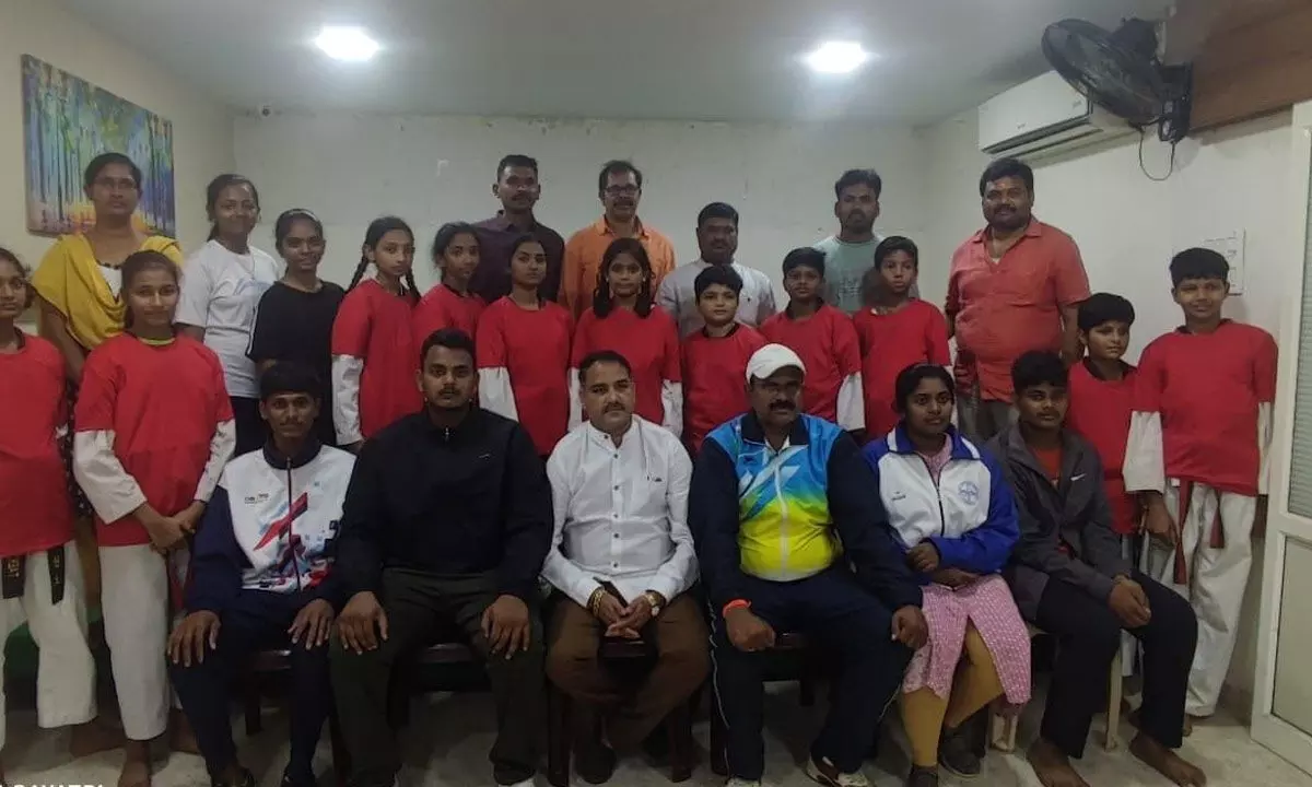 Taekwondo Association district president Gurana Ayyalu and secretary Ch Venugopala Rao with the players selected for national sub-junior competitions