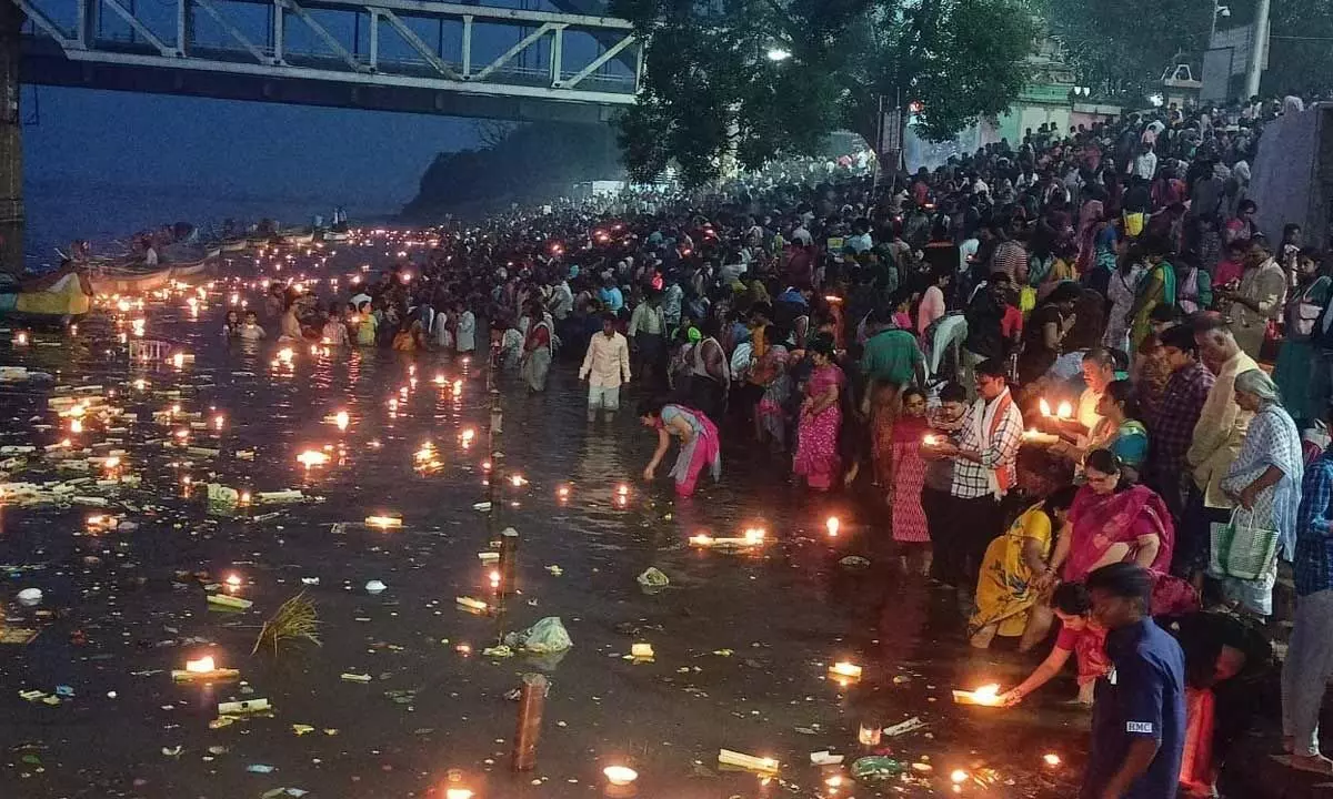 Pushkara Ghat in Rajamahendravaram wearing a festive look with devotees lighting traditional lamps  on the occasion of Karthika Pournami on Monday