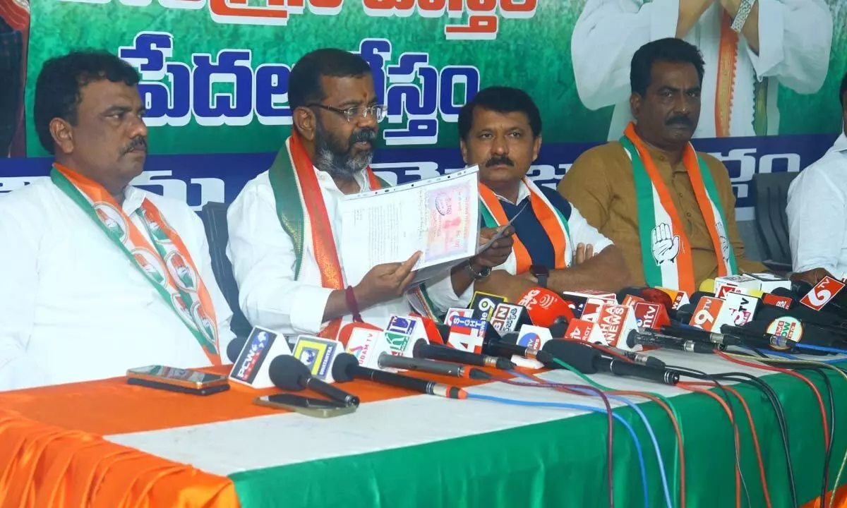 Congress Warangal West candidate Naini Rajender Reddy showing his affidavit to fulfil the implementation of ‘Six Guarantees’ promised by his party at a press conference in Hanumakonda on Monday