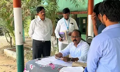 AP higher education principal secretary and Visakhapatnam district electoral roll observer J Syamala Rao examining voter list in west constituency in Visakhapatnam on Monday