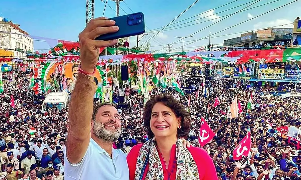 Congress leader Rahul Gandhi with partys general secretary Priyanka Gandhi take a selfie during a roadshow ahead of the Telangana Assembly elections, in Hyderabad on Tuesday